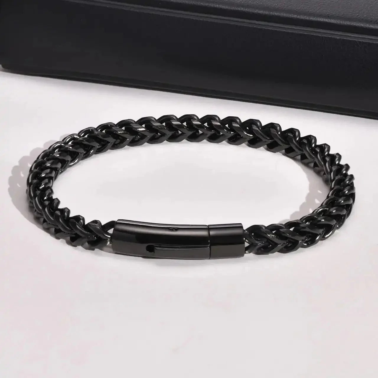 Sleek black braided bracelet with clasp, modern luxury street style accessory from Éclat